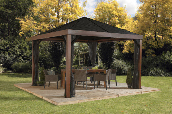 Elegant outdoor living space featuring the Sojag Valencia Gazebo, 12x12 with wood finish, surrounded by lush garden