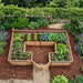 Aerial view of Outdoor Living Today Garden in a Box 12x8 cedar raised bed filled with lettuce, kale and herbs in a mulched backyard garden