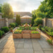 Outdoor Living Today Garden in a Box 8x5 cedar raised bed on a flagstone patio, planted with lettuce, herbs and peppers behind mesh panels