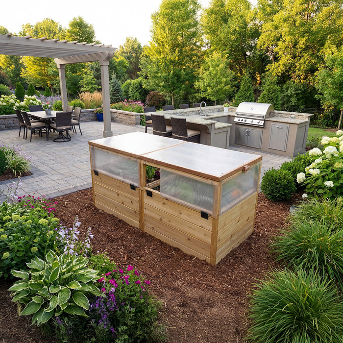 Outdoor Living Today Greenhouse with Garden in a Box 6x3 cedar raised bed with closed polycarbonate lids beside a paver patio and outdoor kitchen
