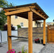 Outdoor Living Today Grill Gazebo 8x5 with cedar posts and metal roof covering a freestanding BBQ grill