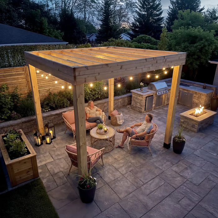 Outdoor Living Today Urban Escape pergola with string lights over backyard patio at night