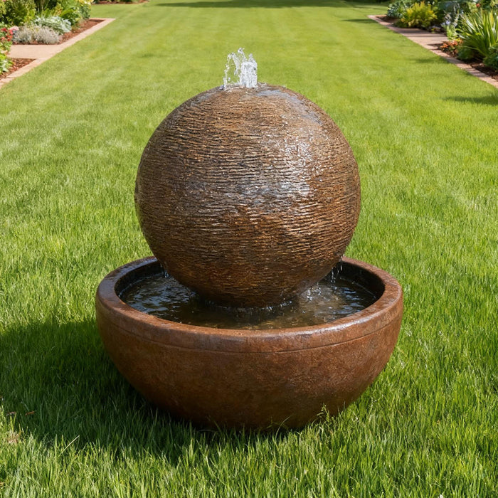 Outdoor Luna Bowl sphere water fountain cascading into circular basin, styled in landscaped garden pathway setting.