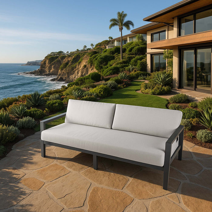 Modern Elementi Outdoor Furnitures 3 seat sofa from the Laguna Collection on a patio with stunning ocean views, perfect for relaxing.