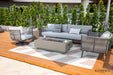 Elementi Milano Collection outdoor set showcased on a wooden deck with a cream and grey patterned rug, featuring a light grey sofa with patterned throw pillows, two matching grey rope swivel chairs with light cushions