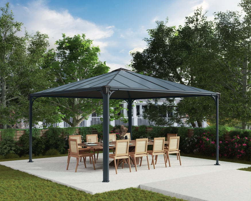 Palram Canopia Palermo 14x14 garden gazebo with grey powder coated aluminum frame covering outdoor dining table on patio surrounded by landscaped backyard.