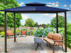 Garden view of the Barcelona Soft Top Gazebo with a blue canopy.