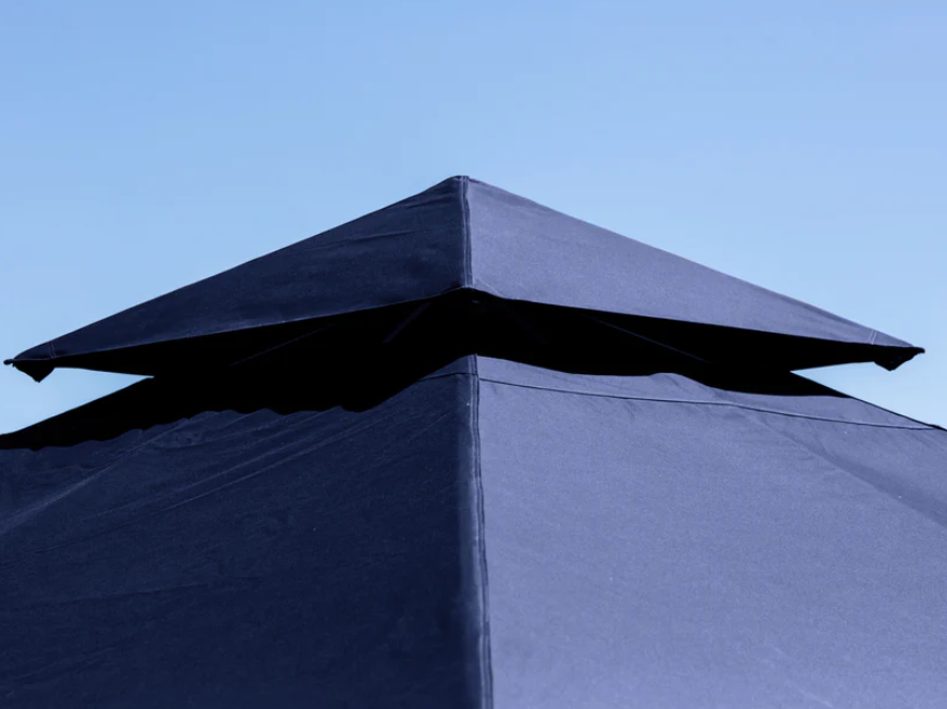 Close-up of the blue canopy of the soft top gazebo, set against a clear blue sky.