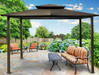 The Paragon Outdoor Barcelona Soft Top Gazebo with a gray canopy over a wooden deck, creating an inviting outdoor dining space