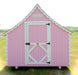 Detailed view of the rear door of the Little Cottage Company Gingerbread Cottage Playhouse in pink with white trim.
