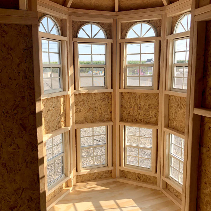 The wooden interior of Little Cottage Company's Grand Mansion playhouse with a table set, ready for children's playtime.
