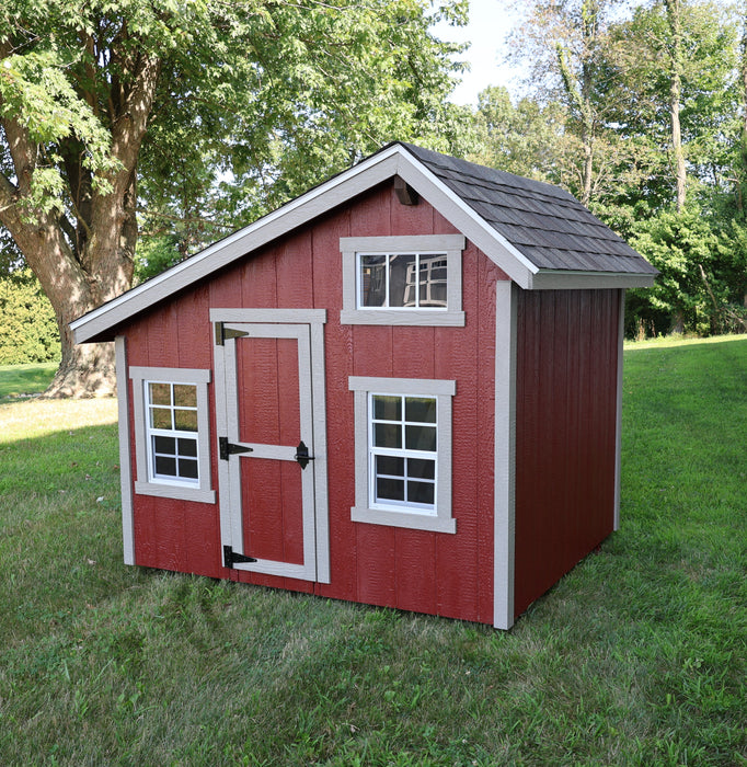 Ez-Fit Kits Playhouse Kit interior showing wood loft with railing, built-in ladder, framed walls, cozy armchair, area rug, and potted plant