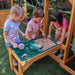 Kids playing with sand on the bear cave playset