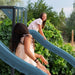 Two girls playing on the Lifetime playset's 9-foot wavy slide.