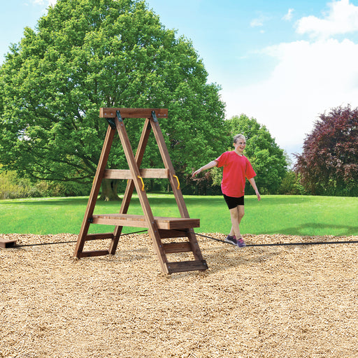 A child using the Playstar Ninja Power Platform in a grassy backyard setting with trees.