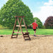 A child using the Playstar Ninja Power Platform in a grassy backyard setting with trees.