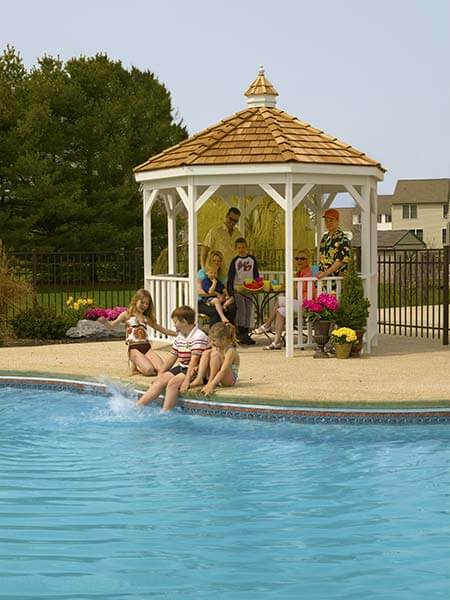 Vinyl Gazebo-In-A-Box with Floor beside a pool with a family bonding