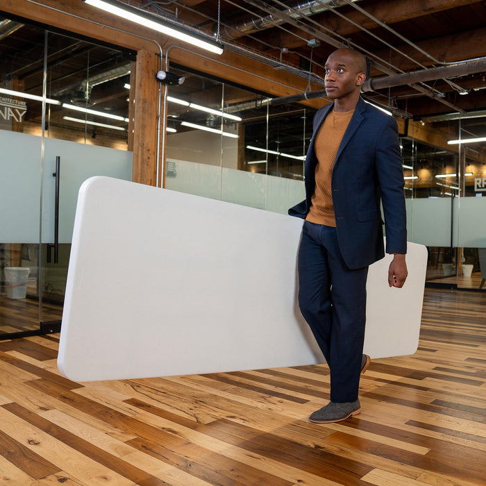 Man carrying folded Lifetime 4 Pack 8-Foot Rectangle Folding Table showing portability and lightweight design
