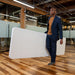Man carrying folded Lifetime 4 Pack 8-Foot Rectangle Folding Table showing portability and lightweight design