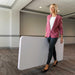 Woman carrying Lifetime 4 Pack 6-Foot Rectangle Folding Table in folded position for easy transport