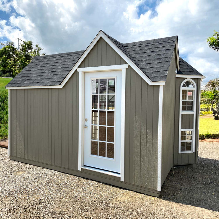 A side view of Little Cottage Company's Grand Portico Mansion playhouse displaying the side door and tall windows.