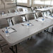 Lifetime 4 Pack Professional Folding Table putty color arranged in classroom style with chairs and water bottles