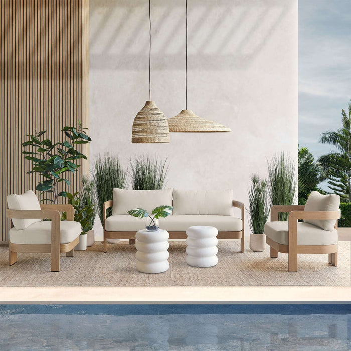 Outdoor poolside setup featuring multiple Real Flame Arlo Outdoor Seat Sofas and coordinating pieces in a modern natural setting.