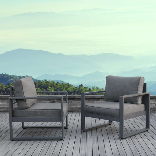 Real Flame Baltic outdoor lounge chairs on a scenic deck with mountain view, showcasing modern patio setup.