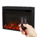 Hand holding Real Flame Marshall Slim remote control pointed at electric fireplace insert with glowing orange flames and realistic log set