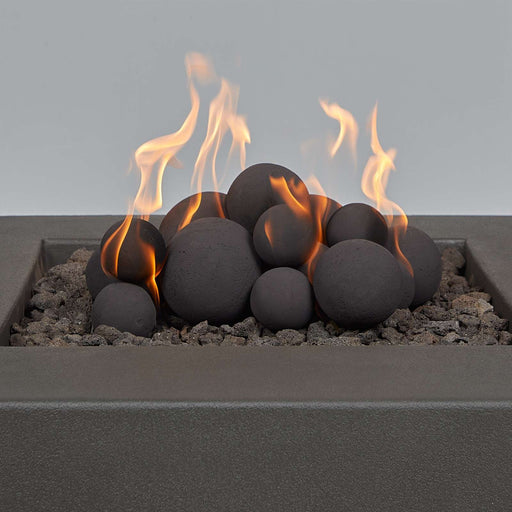 Real Flame ceramic fire pit balls in use with visible flames rising from the stacked spheres

