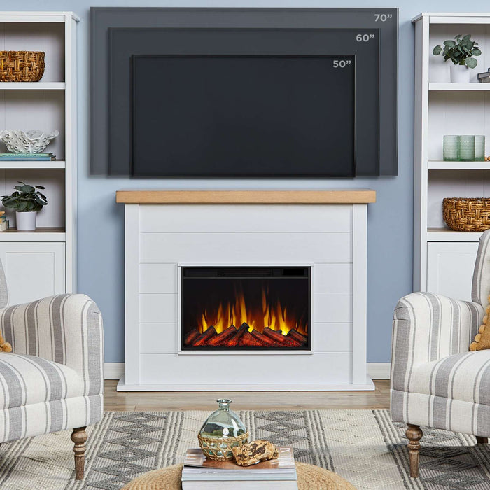 Real Flame Marshall Slim Electric Fireplace in white living room showing compatible TV sizes 50, 60, and 70 inches mounted above oak mantel with built-in bookshelves