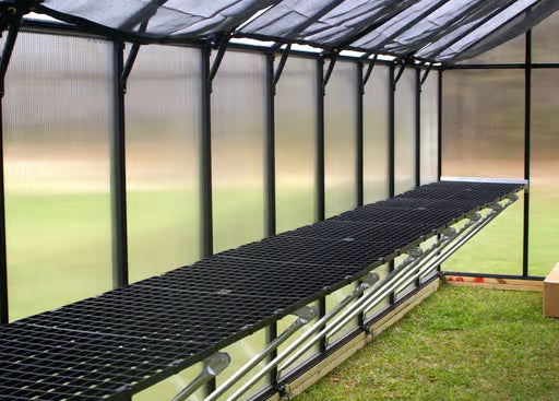 Riverstone Greenhouse Accessories Work Bench System installed inside greenhouse with plants and organized workspace