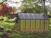 Riverstone MONT Greenhouse Mojave 12 ft with black aluminum frame and tinted polycarbonate panels in backyard garden