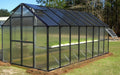 Tinted roof panels on Riverstone MONT Greenhouse Mojave with black aluminum structure and vent window