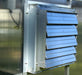 Exterior louver vent of Riverstone MONT Solar Powered Ventilation System installed on polycarbonate greenhouse panel.