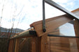 Close-up of the roof bracket detail on the Alton Cedar Fusion Greenhouse, showcasing the metal and wood connection. 