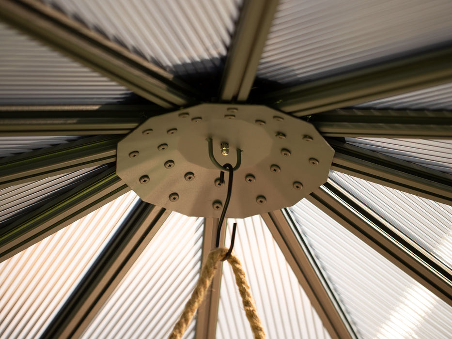 Interior view of the polycarbonate gazebo's roof showing a circular hook fixture for hanging accessories, surrounded by polycarbonate roofing that allows light to permeate the space