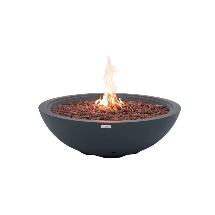This dark gray concrete fire bowl, the Elementi Rose Bowl 48 Fire Pit, burns a tall orange-yellow flame through reddish lava rock on a plain white studio background, highlighting its deep charcoal finish and rounded silhouette.