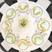 Overhead view of a Lifetime round table set with eight place settings and a floral centerpiece.