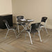 Small round table with four chairs from the Lifetime 4 Pack Stacking Chair collection in office setting.