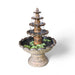 Rust colored Exaco Monaco Fountain with cascading water over four decorative tiers, surrounded by greenery, perfect for gardens and patios