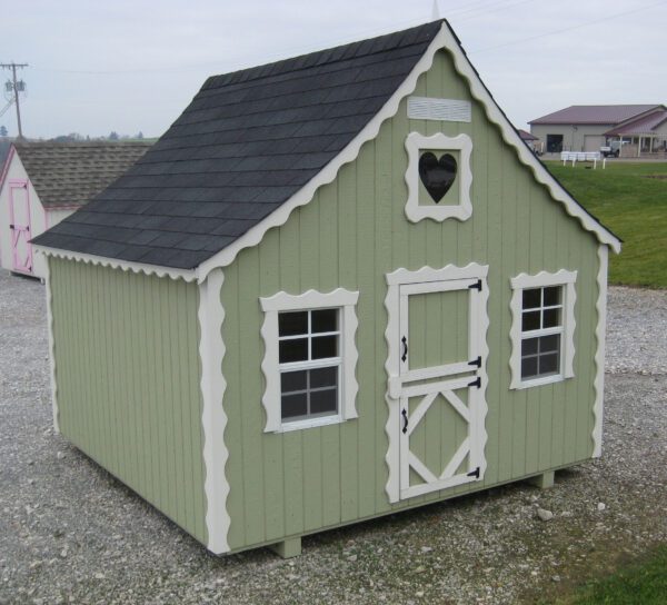Sage green variant of the Little Cottage Company Gingerbread Cottage Playhouse with heart-shaped window and contrasting white trim.
