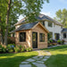 Outdoor Living Today Saltbox Studio Shed 12x8 with cedar siding, black metal roof, and landscaped backyard setting