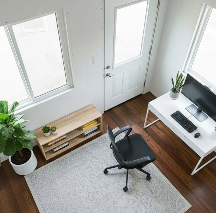 Interior view of Saltbox Studio Shed 12x8 set up as a home office with desk, chair, windows, and wood flooring