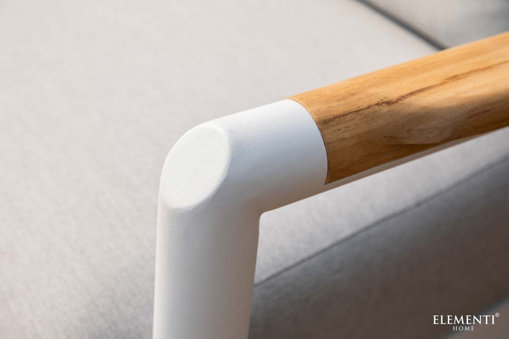 A close-up of a smooth white joint connecting to a wooden armrest on a piece of Elementi Outdoor Furniture from the Santorini Collection