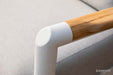 A close-up of a smooth white joint connecting to a wooden armrest on a piece of Elementi Outdoor Furniture from the Santorini Collection