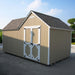 Tan backyard storage shed by Little Cottage Co., barn-style double doors with white trim and scalloped roofline, companion structure to playhouse