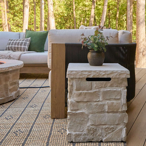 Real Flame Scottsdale Propane Tank Cover styled as a rustic outdoor side table beside a patio sofa set.
