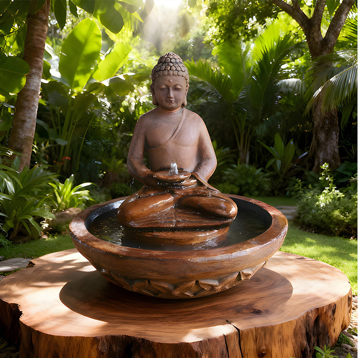 Serene Buddha garden water fountain with round bowl basin, flowing water feature, set in lush tropical backyard landscape.