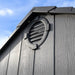 Close-up of the Lifetime storage shed's round gable vent against a blue sky.